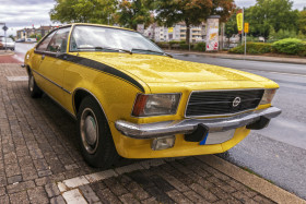 Stock Image: Beautiful old yellow car Opel Ascona A on a rainy day