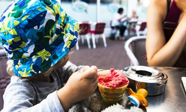 child with strawberry ice cream cup child with strawberry ice cream cup