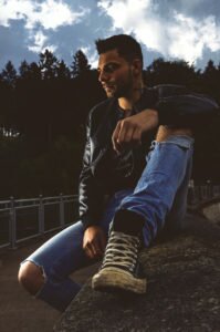 sitting man on a wall
